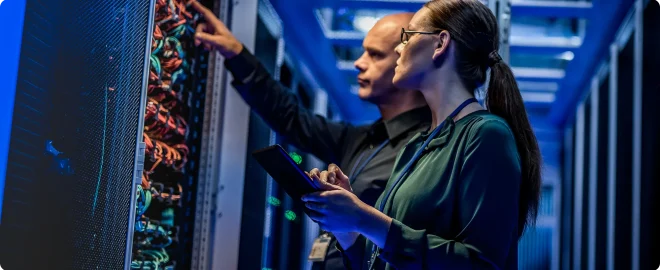IT engineers checking servers in server room