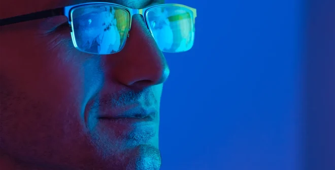 The portrait of the happy businessman in glasses