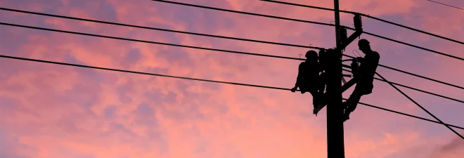 Electrician worker climbing electric power pole to repair the damaged power cable line problems after the storm. Power line support,Technology maintenance and development industry concept