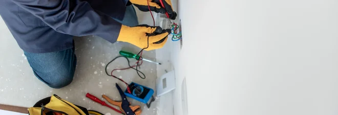 Man testing electricity with multimeter