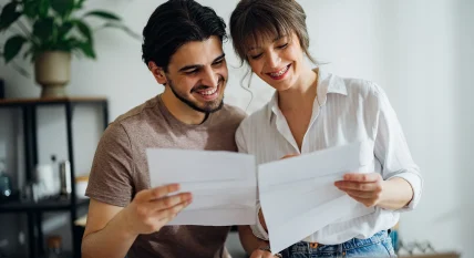 Cheerful Couple Paying Bills at Home