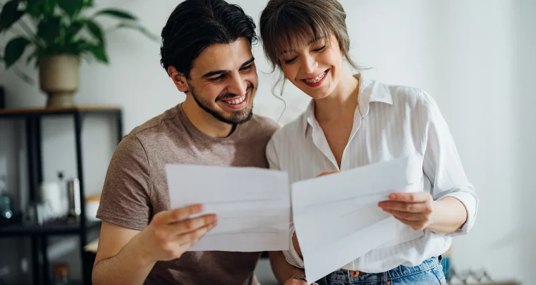 Cheerful Couple Paying Bills at Home