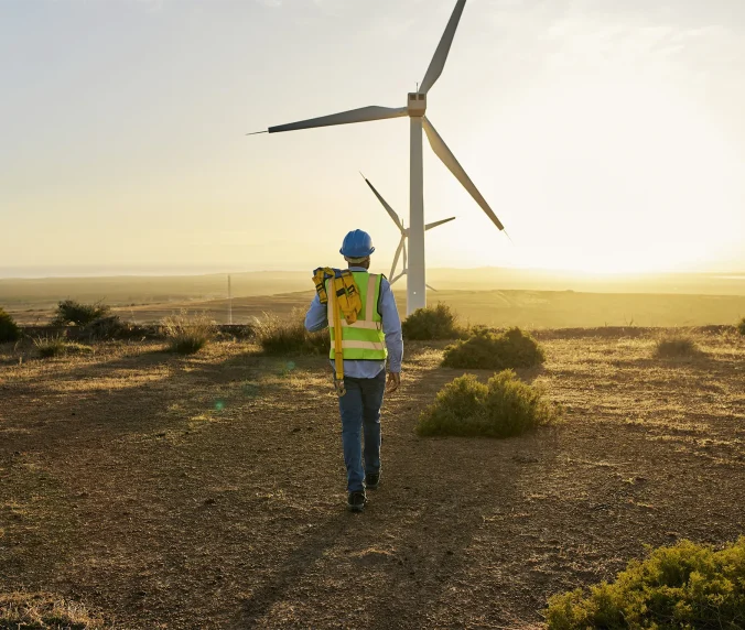 Engineer, wind turbine and clean energy with man and environment, sustainability and natural with technology. Renewable, engineering with agriculture, electricity and windmill inspection