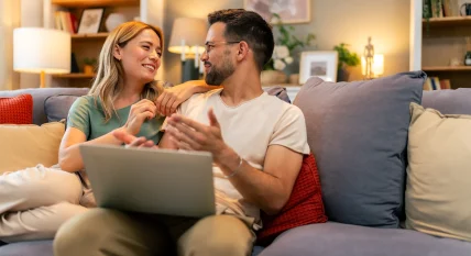 Couple paying bills online, calculate expenses at home
