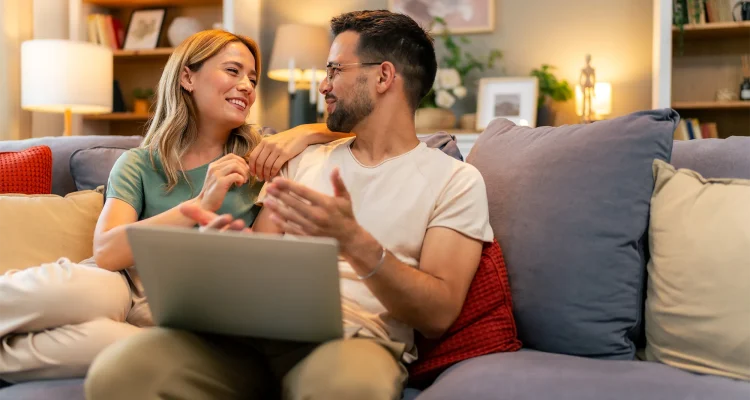 Couple paying bills online, calculate expenses at home
