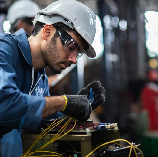 Engineer manual workers standing in a aluminum mill and working together. used professional equipment. Manual workers cooperating while measuring a electronic